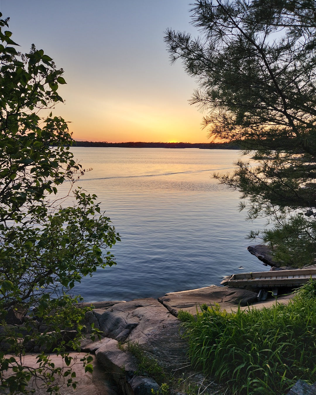 Sunset over the water in Ontario cottage country, photographed by Matt