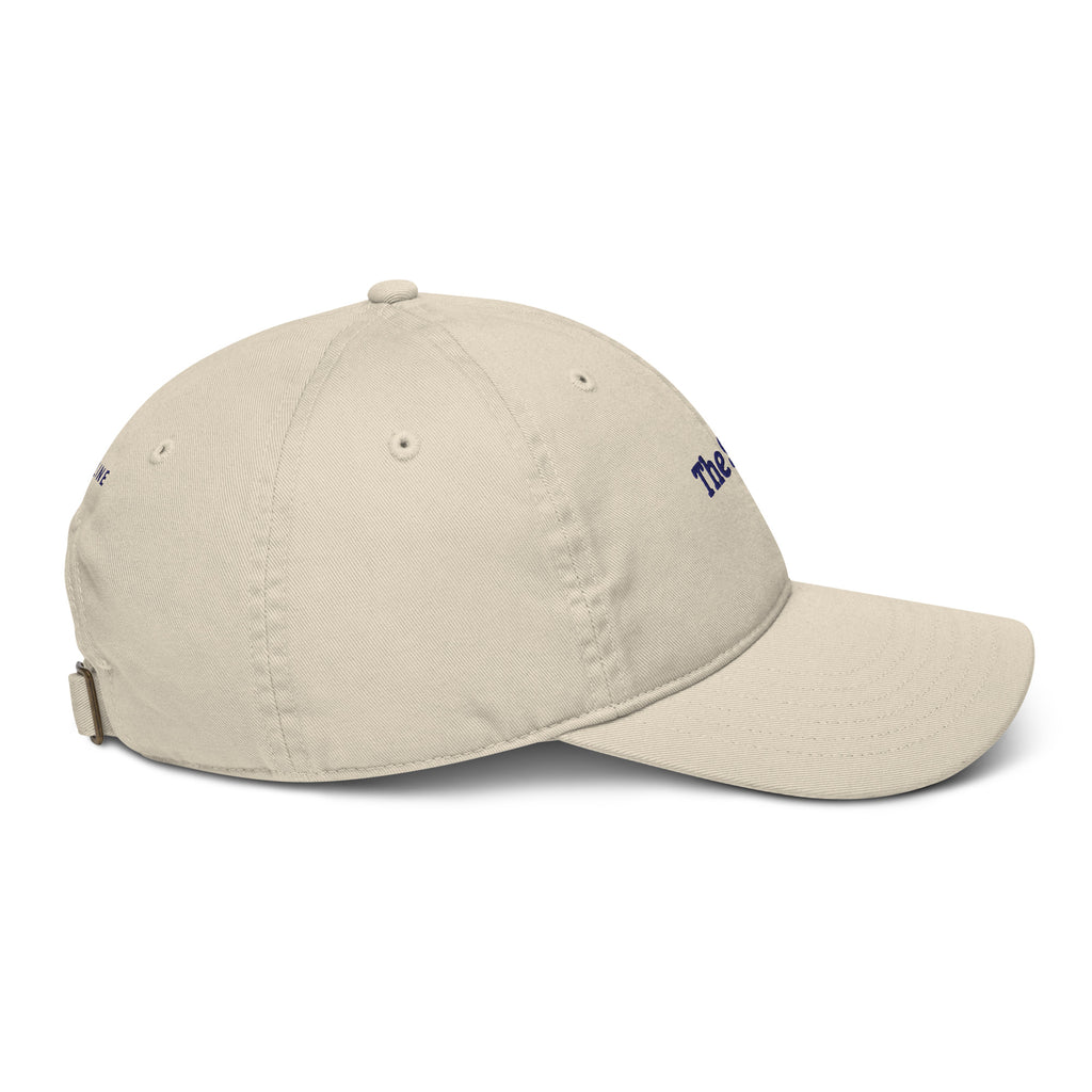 The Snug Cap in Oyster with navy embroidery, right-side view
